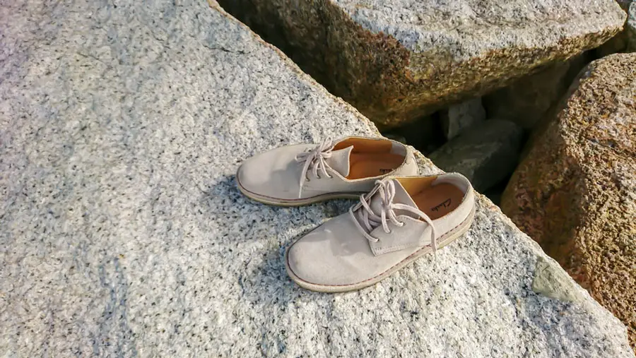 View of a Clarks shoes on top of a stone