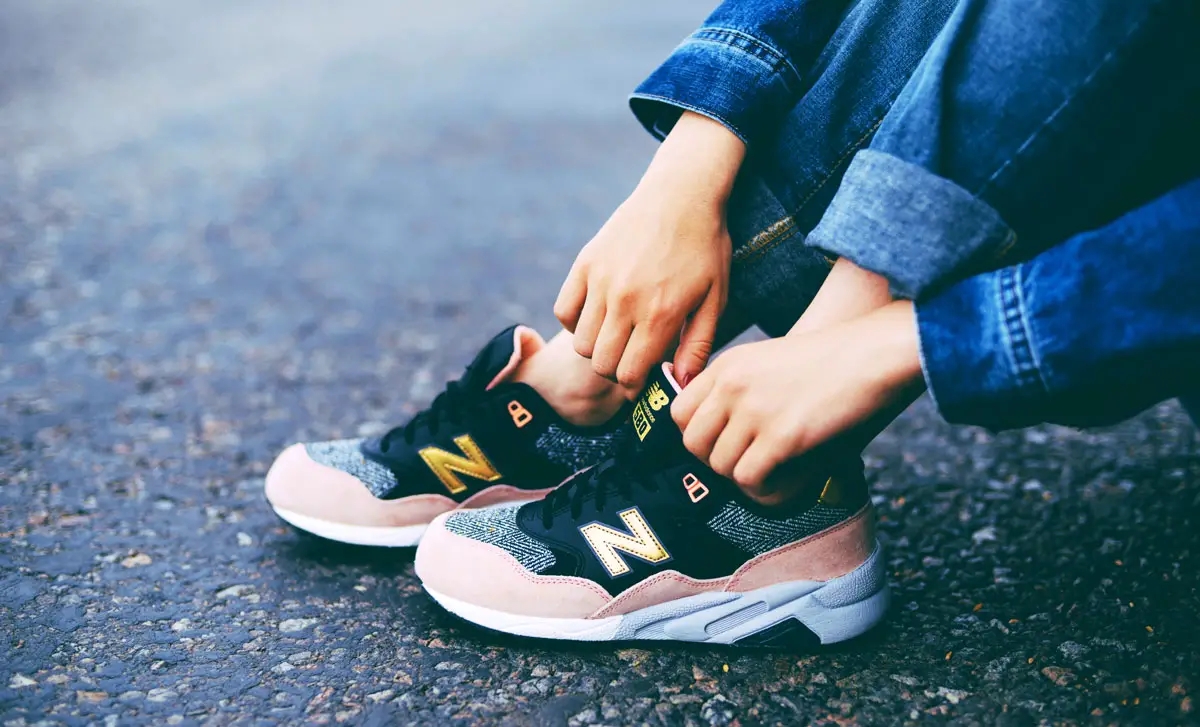 View of a woman in denim wearing a New Balance shoes