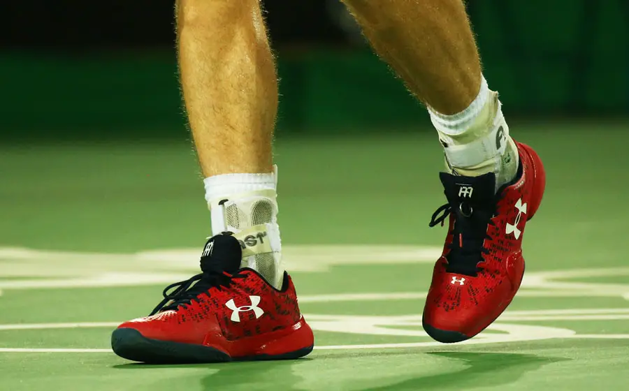 A tennis player wearing a Under Armour tennis shoes