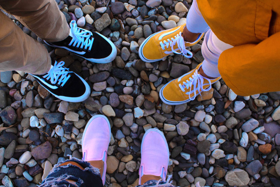 Siblings wearing different kinds of Vans shoes